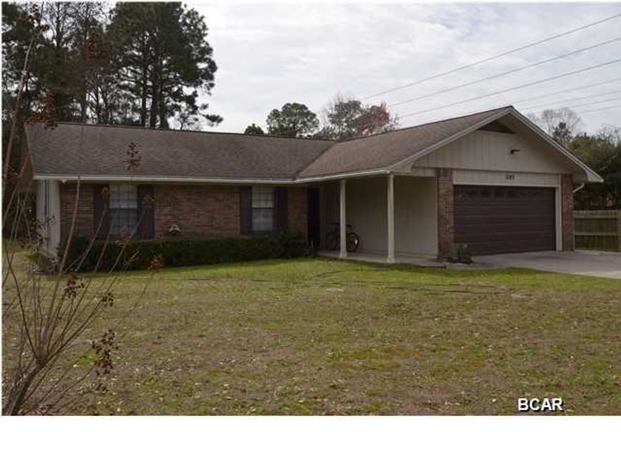 Amazing price on this well kept 3 bedroom, 2 bath home located on a corner lot in Lynn Haven. This home has been well maintained with a new roof in 2004, new A/C in 2014, a finished Florida room with a separate A/C and wired with 220 for a hot tub and many new fixtures throughout the home. The seller is only the second owner to ever live in the home and it shows well! The living area is very large and opens to the Florida room and the dining room. The kitchen is a galley style kitchen with plenty of cabinet space. All three bedrooms are quite large too. The exterior of the home has brick and wood siding that has been well maintained also. The water heater is on a timer for efficiency and the garage door opener was just serviced too. In the back yard there is a 12x20 workshop and