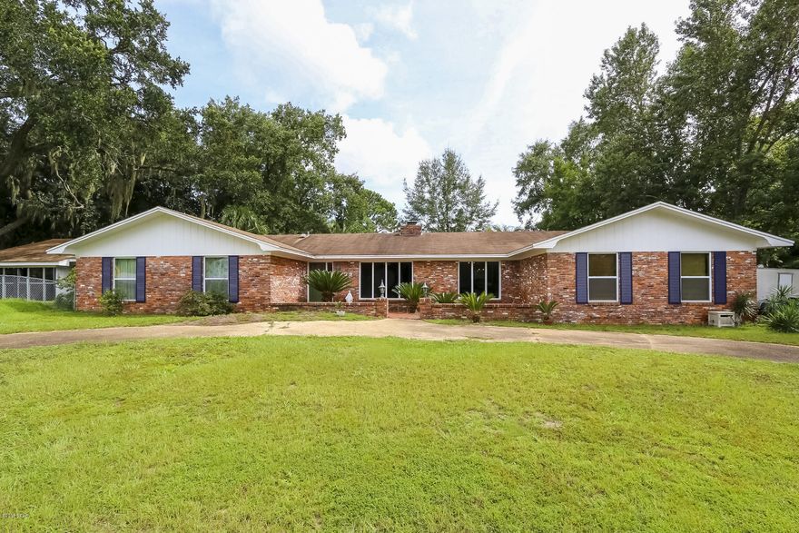 Looking for a roomy home with an amazing entertaining space and a pool? You've found it in this very spacious brick home on nearly half an acre corner lot. Enjoy the crystal clear pool/entertainment area that has been enclosed by a 1272 sqf addition. Home also features newer thermal windows; formal living and dining rooms; family room with massive brick wall fireplace; Heated and cooled Florida room; Kitchen with big walk-in pantry; breakfast room. Master suite includes walk-in closet and double vanity plus makeup counter in bath. Fourth bedroom has been converted to a rustic office with built-in shelving. Double garage,carport, driveway, and lots of space for RV or boats. No flood Insurance required and no City Taxes. Make your appointment today to view this unique home.