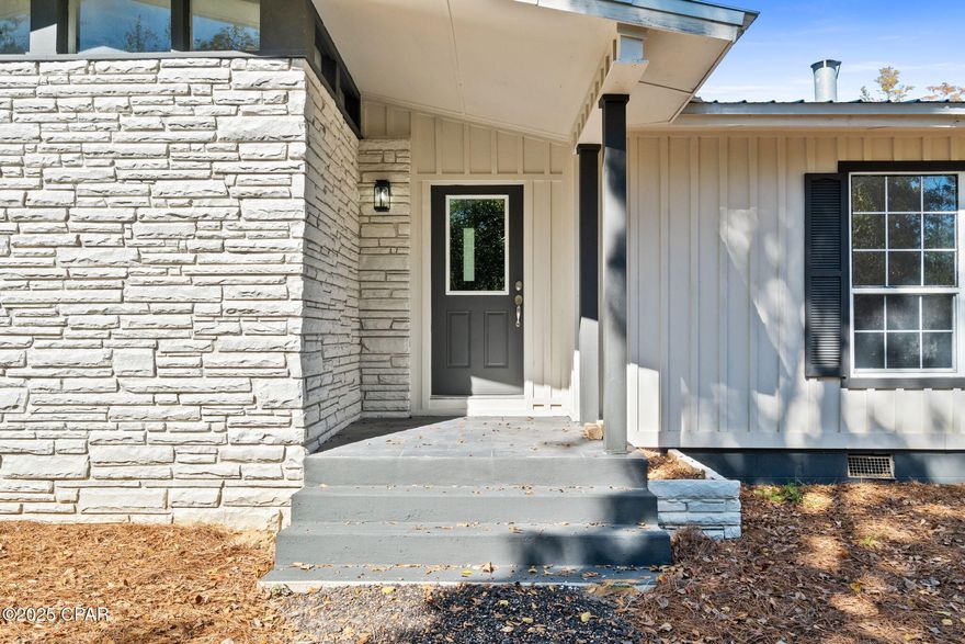 Welcome to 364 Lister Dr — your own private lakefront escape tucked away on one of Wewahitchka's most peaceful stretches of water. This updated home brings together rustic charm, modern comfort, and wide-open views that make every day feel like a getaway.

Inside, you'll find a bright, open layout with vaulted, beamed ceilings and a striking full-length stone fireplace that anchors the main living area. The kitchen has been beautifully refreshed with white cabinetry, stainless steel appliances, granite countertops, and a center island that's ready for cooking, gathering, and game-day snacks. Large windows and sliders pull in tons of natural light and frame the lake like a piece of art.

Step outside and you'll understand why this property is so special. The huge open porch runs along the back of the home, giving you the perfect spot to relax, grill, or watch the sun dip over the water. The backyard opens right up to the lake with plenty of room to cast a line, launch a kayak, or build the dock setup of your dreams. Whether you're into fishing, boating, or just soaking in the quiet — this place delivers.

The home sits on a generous, private lot surrounded by mature trees and nature. Fresh updates throughout make it move-in ready, so you can focus on enjoying the good stuff: the breeze, the view, and the laid-back lifestyle Wewa is known for.

If you've been looking for a lake house with character, space, and unbeatable scenery, this is the one. Come see what life on Lister Drive feels like.