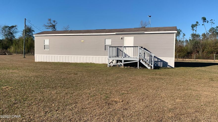 This immaculate mobile home on 1.5 acres is located in close proximity to the Calhoun County Airport and the Chipola River allowing you the convenience of rural living but a short distance to Blountstown and Marianna. This home is a 2014 model that has never been fully occupied and utilized as a vacation home, leaving it immaculate and in brand new condition. This property also offers a 30x18 enclosed shed for storage. This home also offers a large front porch to overlook a large portion of the property. The entire perimeter is fenced.