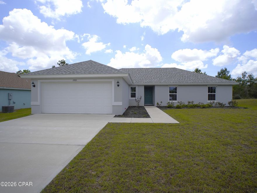 Seize the rare opportunity to own the model home--the Lavender floorplan by Homes by Deltona--beautifully situated in the tranquil community of Sunny Hills. As you step inside this four-bedroom, two-bathroom gem, you're greeted by a spacious open concept living area, crowned with a majestic, vaulted ceiling that elevates the home's aesthetic. The kitchen, designed to satisfy any culinary enthusiast, boasts a central island, sleek granite countertops, and state-of-the-art GE appliances such as a garbage disposal, fridge, dishwasher, range, and over-the-range microwave. The home features luxurious and practical luxury vinyl plank (LVP) flooring throughout the living areas, enhancing both style and durability. Each bedroom creates an open and airy atmosphere, complemented by soft, cozy carpeting for a serene escape. Constructed with sturdy concrete block, this residence promises durability and longevity. The intelligent split bedroom floor plan provides privacy and comfort, with a master suite that includes a large walk-in closet and dual vanity sinks--ideal for relaxation. Step outside to a professionally landscaped yard with an efficient irrigation system, ensuring that your green space thrives beautifully all year long. Additionally, enjoy the confidence that comes with a 10-year builder's warranty. Located in the peaceful Sunny Hills, yet a brief drive from the stunning beaches of the Emerald Coast, this model home is a perfect blend of tranquility and accessibility. Don't miss out on making the Lavender floorplan your forever home!