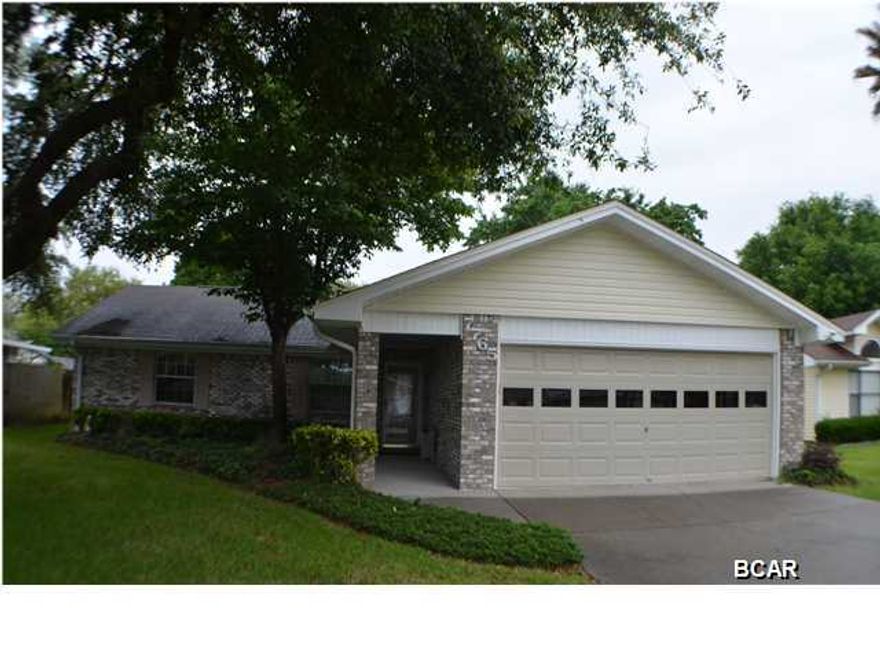 You will not find a more meticulous and well cared for home so close to Tyndall. An immaculate 3 bedroom 2 bath home featuring a beautiful bright and window lined Florida Room. The moment you enter from the covered walkway into the designed tiled foyer you will soon be greeted by the stunning true hard word floors that are found throughout the home. The living room features an open cathedral ceiling and brick fireplace. The dining room is nicely appointed with a bay window overlooking the well landscaped back yard. Speaking of yard, it is well designed with mature foliage and trees for plenty of shade. Outside you will also find a yard building with it's own window A/C unit. The bedrooms are well laid out with plenty of space and the master shower is a newly redesigned tiled walk-in.