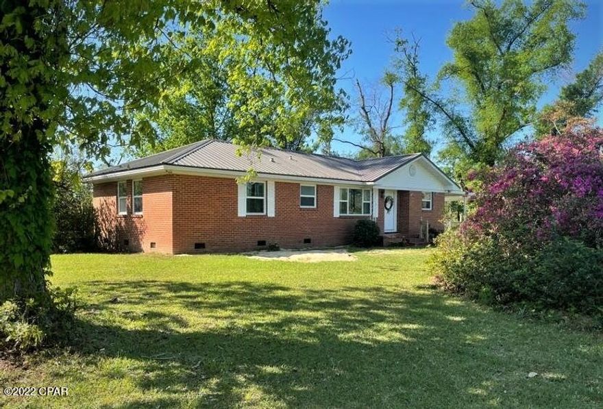 You've got to see this beautiful brick home located just outside of Marianna, Fl sitting on 1.88 acres! Upon entering the front door you are greeted by a large living area perfect for family. The dining room and kitchen set off to the right and the laundry room is located off the back. To the left is a nice hall area that the 3 bedrooms and bathrooms set off of.  The master bedroom boasts a large walk-in closet and sitting vanity area along with a full master bathroom. This house includes an oversized spare bedroom that could be turned into 2 rooms. If you love being outdoors, you will love the yard that this home has to offer. Located in the backyard is a large pole barn and 2 sheds. Off the back of the house there is large covered deck perfect for entertaining. There's also a carport.