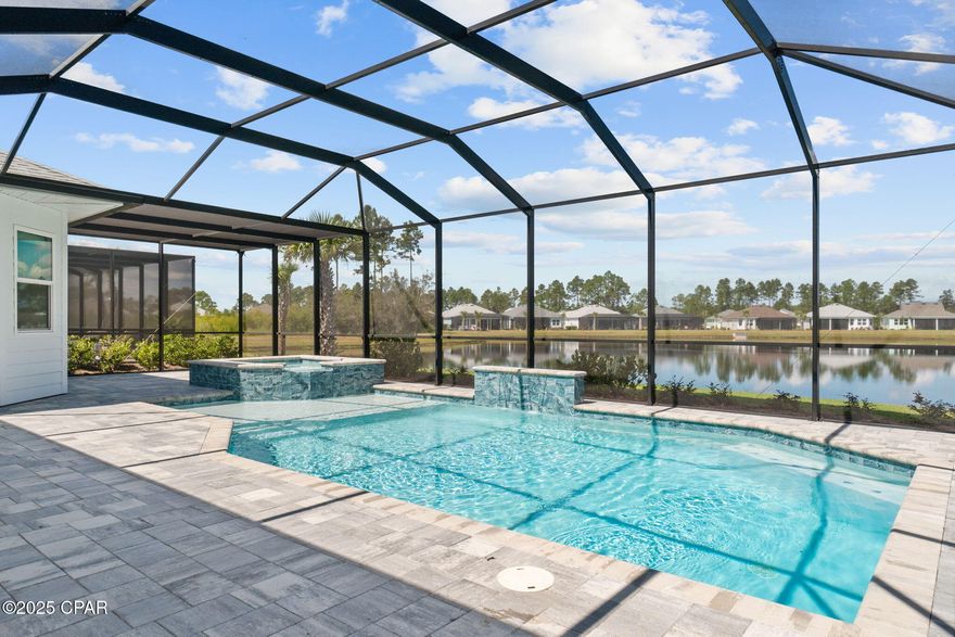 PREMIUM POND LOT! Close-in phase 4 on a sought after Island Collection only street! Highly upgraded home with luxury POOL & HOT TUB/SPA! 

This spectacular TRINIDAD BAY, Island Collection home offers an unmatched blend of luxury, comfort, and the Latitude lifestyle. Perfectly positioned on an expansive pond lot, this residence showcases a saltwater, heated pool with spa and waterfall feature, surrounded by pavers and fully screened for year-round enjoyment. 

Interior Features include; Level 5 Colada kitchen cabinetry with Sub-Zero refrigerator, KitchenAid double oven/microwave, and Wolf gas cooktop
Level 5 Quartz countertops, range hood, oversized island, and spacious walk-in pantry. Large, open dining and living areas plus a separate family room with fireplace. Den/office with built-in cabinetry, wet bar with wine cooler, and glass French doors. 

Custom window treatments, designer paint, upgraded crown moldings, and 8 ft doors throughout. 3 bedrooms and 3 full baths, with all guest baths upgraded with tile showers. Primary suite overlooking the pool and pond, spa-like bath with zero-entry frameless shower enclosure and rain shower upgrade. 

Designer tile flooring throughout the home. Hurricane Impact windows/doors in entire home/garage. Huge laundry room with built-in cabinetry, laundry sink, and newer washer/dryer. Spacious 3-car garage with upgraded floor coating, insulation package, and smart garage door openers with camera function. Whole-house WiFi, Sonos and theater package, built-in speakers on the lanai and in the den/office areas. Gorgeous paver driveway and walkway. 

Every detail of this home was carefully designed and upgraded for both beauty and functionality. From the luxury kitchen and spa-inspired primary suite to the resort-style outdoor living, this is a home where no detail was spared. 

Living in Latitude Margaritaville Watersound means embracing a true resort-style, active adult 55+ community, coastal lifestyle designed for fun and relaxation. At the heart of it all is the Town Square where live entertainment fills the air on a daily basis and every Fri/Sat. night! Homeowners enjoy: The Resort-style pools- perfect for lounging in the Florida sunshine or enjoying a swim with friends. State-of-the-art fitness center & group classes - including yoga, spin classes and lap pool and spa, water aerobics to name a few. Walking, biking, and golf cart trails that wind through the community with easy access to all amenities and a underpasses for safe and convenient access throughout the neighborhood. Sports courts - including pickleball, tennis, and bocce, basketball encouraging friendly competition and active living. Kayak launch for adventure seekers, Last Mango Theater for shows and events, ceramics and wood working shops, pet grooming and a dedicated dog park. 

Beyond the amenities, Latitude Margaritaville Watersound offers a low-maintenance lifestyle—with lawn care included in HOA dues, the home has a 10 structural warranty from the original owners close date.

Whether it's a sunset golf cart ride, cocktails by the pool, or mingling with neighbors at one of the many social events, this is a place where every day feels like a vacation. This home is more than just a showcase of luxury and upgrades—it's your gateway to the Latitude Margaritaville lifestyle. This home offers comfort, elegance, and the vibrant energy of Latitude Margaritaville Watersound, the essence of coastal living at its finest.