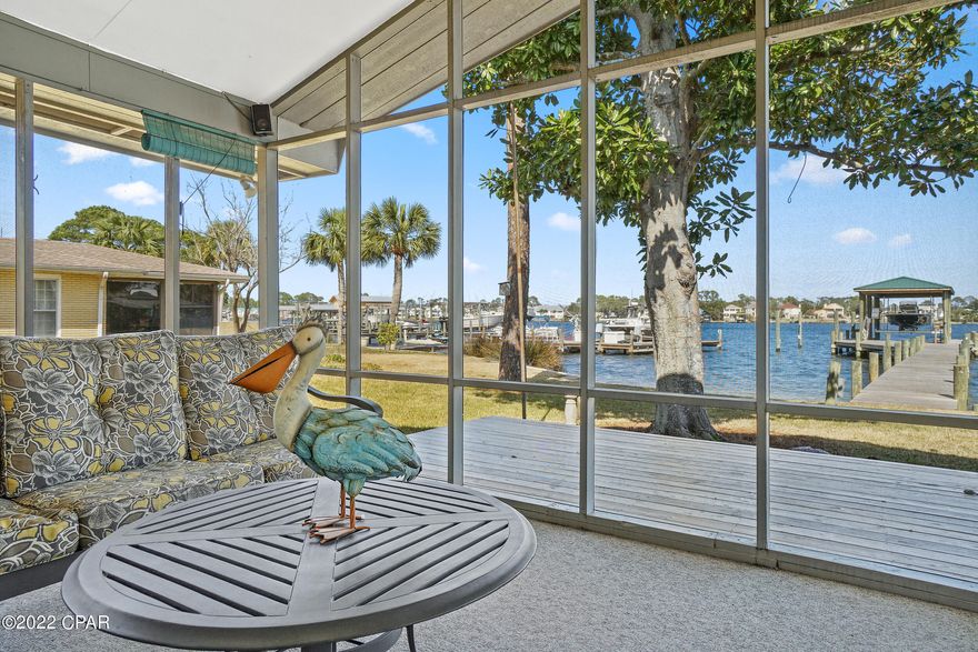 CURRENTLY UNDER CONTRACT, SELLER ACCEPTING BACKUP OFFERS'  A boater's paradise awaits in this unique two-in-one investment opportunity on South Lagoon Drive in Panama City Beach. Enjoy deep water access to St. Andrews By, Shell Island and the Gulf of Mexico with 75 feet of water frontage just moments from the bridge. A brand new electric- and water-enhanced dock with 8,000-lb. boat lift, covered boat house and fish cleaning station enhance its appeal. The structure of this purchasing opportunity includes two lots, one with a three-bed, two-bath home and an adjoining vacant lot, both adding to .27 acres. This allows for numerous possibilities including short-term rentals through platforms like Airbnb; building an additional home on the extra lot; adding on to the existing home; or, demolishing the existing home to build a larger residence with guest house and pool. The 1,290-sq.-ft. cottage features a screened porch overlooking the lagoon and numerous updates including a new roof, new septic system, new Zoysia grass with irrigation system including French drains and new pavers. Pictured furnishings convey with purchase. South Lagoon Drive rests in an enviable location near the beach, a public boat ramp, Rick Seltzer Park beach access, outdoor activities and fine dining and boutique shopping. Call today for a showing. Buyer should verify all data and dimensions.