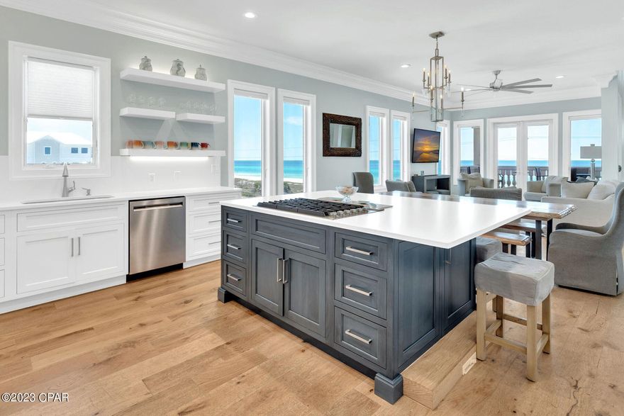 CURRENTLY UNDER CONTRACT, SELLER WILL CONSIDER BACKUP OFFERS
Few places on the coast can beat the forever gulf views from this five-bedroom vacation home. Wake up to the sound of the waves and look forward to a day of beach activities just across the road or spend the day hanging out in the private courtyard with pool and spa. Throw open the French doors to any of the 4 covered terraces to enjoy fresh sea breezes, 2 of which offer uninterrupted gulf views. The property was recently renovated with new walls, flooring, cabinets, lighting, furnishings, new AC and water heaters along with new appliances and quartz kitchen countertops. There's ample parking on the pavered driveway and steps lead up to a porch and stained-glass entrance door. The first floor consists of an oversized air-cooled garage that is set up as a game room with foosball, dart board and room for beach gear. The garage includes elevator and interior staircase access as well as entry to the cabana style guest studio with queen over queen bunk beds, a pull-out sofa in the living area, a full kitchen, and an en suite bathroom which has an exterior door allowing direct access to the pool and hot tub. This makes for ideal accommodations for large families or groups. French doors lead you out to the enclosed courtyard with a private pool and sun terrace. Take the elevator to the third floor, where beautiful, polished wood flooring and large picture windows grace the entire length of the main living space. This level includes a formal dining area and a generous open sitting room. The family-sized kitchen has new inset white cabinets, quartz countertops and a gas cooktop on the contrasting blue island. There's ample space to enjoy casual dining on cushioned stools at the bar or more formal seating around the dining table. Included on this floor is a bedroom with an ensuite bath along with a private balcony. The second floor is dedicated to 3 more bedrooms, additional bunkbeds, all with en suite bathrooms, and laundry room. Donuts, biscuits and Carousel Supermarket mere blocks away, and dining and entertainment at Pier Park or 30A just a few miles by car. Investors will appreciate that the property has a seasoned rental manager and is already heavily booked for 2023.