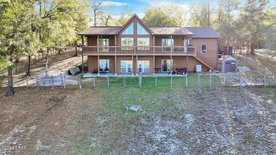 CURRENTLY UNDER CONTRACT, SELLER WILL CONSIDER BACKUP OFFERS. Welcome to lakefront living! This captivating 4-bedroom, 3-bathroom log cabin, complete with a loft space, offers a rustic yet luxurious retreat. Featured with beautiful pine interior walls and a vaulted ceiling, almost every room provides panoramic views of the tranquil lake.

Step outside onto the expansive covered deck that spans the entire backside of the house, offering the perfect spot to relax and take in the views. The bottom floor features a roughed-in kitchen, living area, utility room, bedroom, and bathroom, providing versatility for guests or as a cozy in-law suite.

Recently painted exterior, HVAC replacement 4 years ago, well pump and water filtration system 3 years ago ensure this home has been efficiently maintained. Situated on .74 acres, this property also includes an additional 1.77 acres directly in front, offering endless possibilities for outdoor activities and enjoyment.

Don't let this lakeside retreat slip away! Schedule your showing today