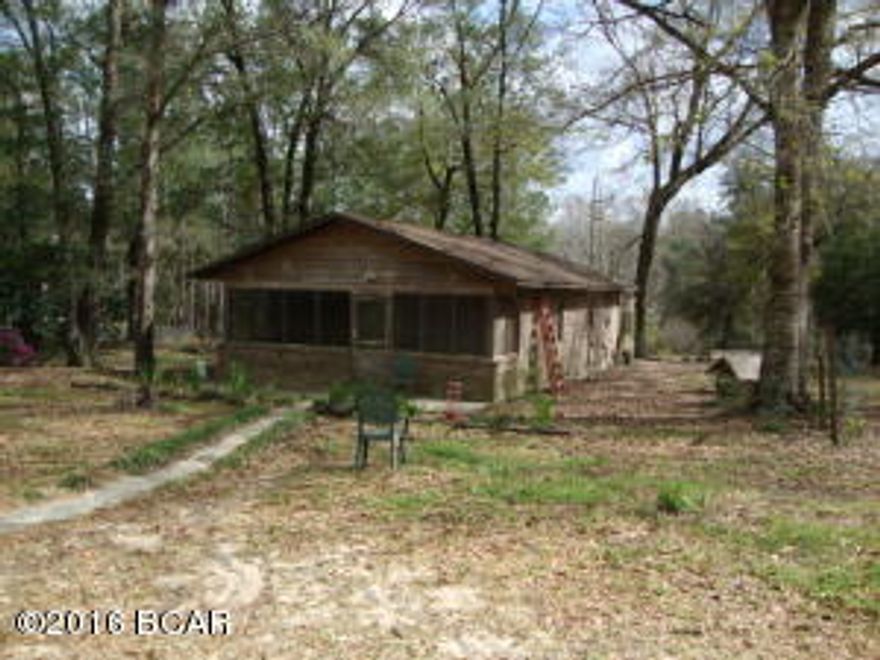 Private and Cozy is this 2 bedroom 1 bath Brick home on 5 Acres. Beautiful setting under the oaks. Has open floorplan for living room, dining and kitchen. New Metal Roof. Newer central heat and air. Large landry room. Screened Front and Back Porches. House sits back from the road with nice cleared pasture in the front. Fish pond and wooded area on the back. Large barn/workshop. Needs a little TLC. Nice and quiet area. Check it out today.