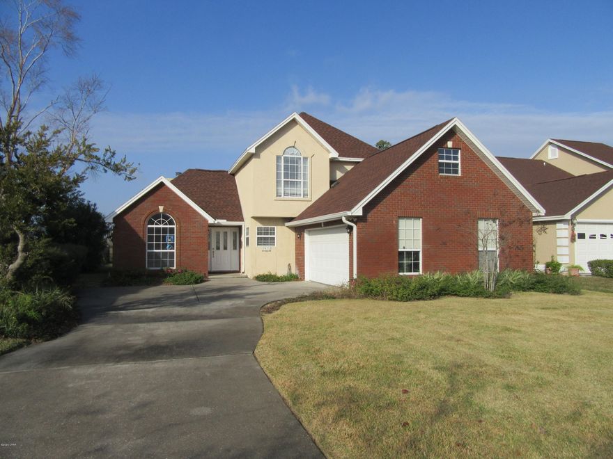 Brick and stucco home located on the 5th green of Panama Country Club which offers private championship golf, bay front clubhouse, and pool...Interior of home offers tiled living room with fireplace, formal dining room with laminate wood flooring, kitchen with custom cabinets and gas stove, breakfast room, downstairs master bedroom, half bath, and three bedrooms (one bedroom would make great play room/media room, it measures and one bath upstairs...Exterior offers side entrance two car garage, open patio, large oak tree, sprinkler system, and great views of the course... All sizes are approximate, please measure and verify if important. School assignments are subject to change, please check with Bay County for most accurate information. PETS NOT ALLOWED!