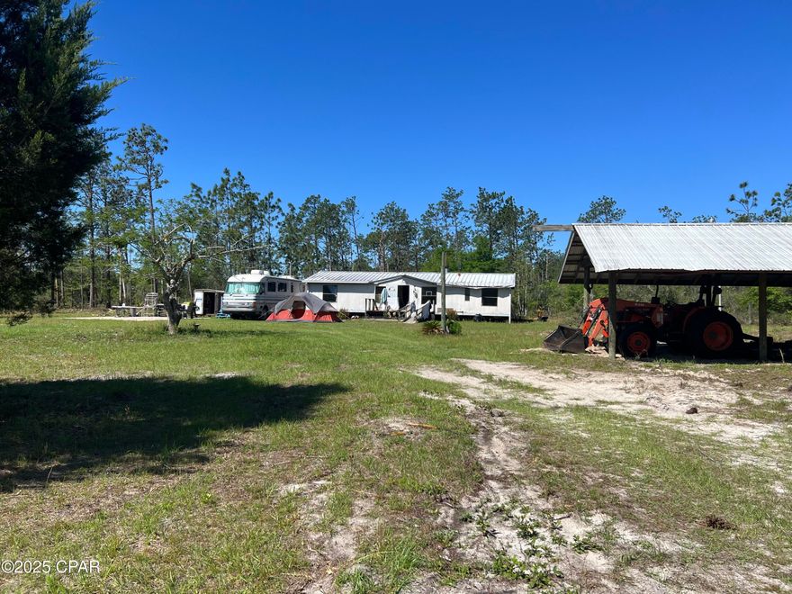 Experience the charm of country living on this 10-acre property. Enjoy the tranquility of rural life with a reliable well and septic system. The property features a newly installed RV electric pole, ensuring modern conveniences. Additionally, there is a 10 x 20 pole barn. This property offers a serene retreat with ample room for outdoor activities and future development. There is a double wide mobile home on the property that will either need to be renovated or removed. It does not leak.