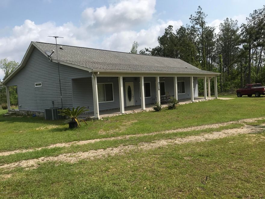 PRIVACY!  You will love this quiet country retreat on 10 acres with a pond.  This very nice 3 bedroom 2 bath split plan has 9' ceilings, crown molding, custom cabinetry and ceramic tile throughout the home.  Large walk-in double head shower in the master bath.  All interior doors are pocket doors.  Porches on the front and back of the home extend the length of the home for enjoying your country living.  There is a drive through carport attached to the home.  Includes a very nice 60x32 workshop with several rooms inside and two pull down garage doors.  Great family home!