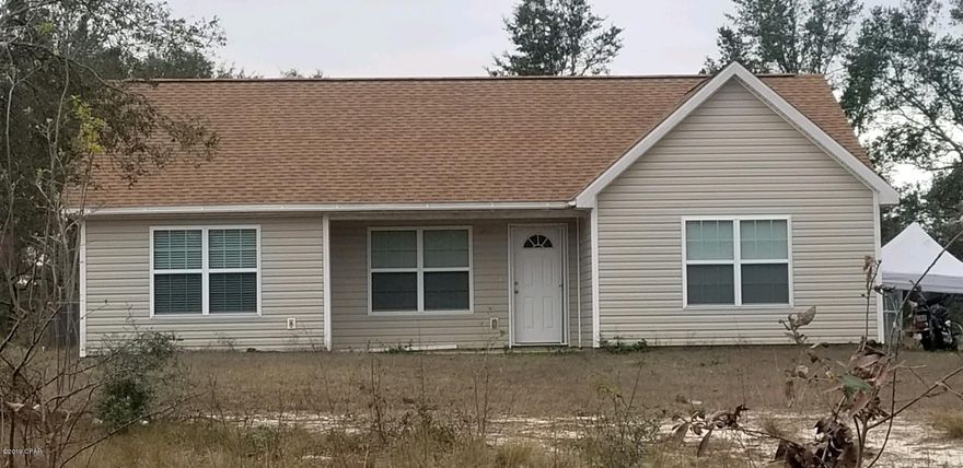 Construction on this home was completed in October 2017 in the security gated lake subdivision of Leisure Lakes. It has a split bedroom plan with a vaulted ceiling in the family room, a trey ceiling in the master bedroom, and recessed lighting throughout. The kitchen has dark self-closing cabinets and drawers, colored glass backsplash, stainless steel appliances, a panty with an etched glass door, and an island with a breakfast bar. The dining area also has a glass door for access to the back yard. Most of the house has ceramic tile that looks like wood planks, and carpet in the 3 bedrooms. There is an exit door to the outside through the utility room on one side of the house. The front porch is covered. The lot size is 2.20 acres and is flat.