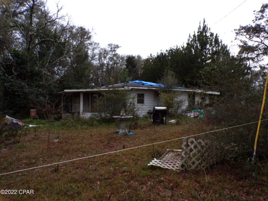 Four bedroom one bathroom older home in Ebro Fl needing some TLC offered as is.  The home sits on a 1.1 acre lot, is near Pine Log State forest. Sand Pine Recreational area, and has a  propane tank, is partially fenced, and has covered storage.  All sizes are approximate or taken from other sources please verify according.