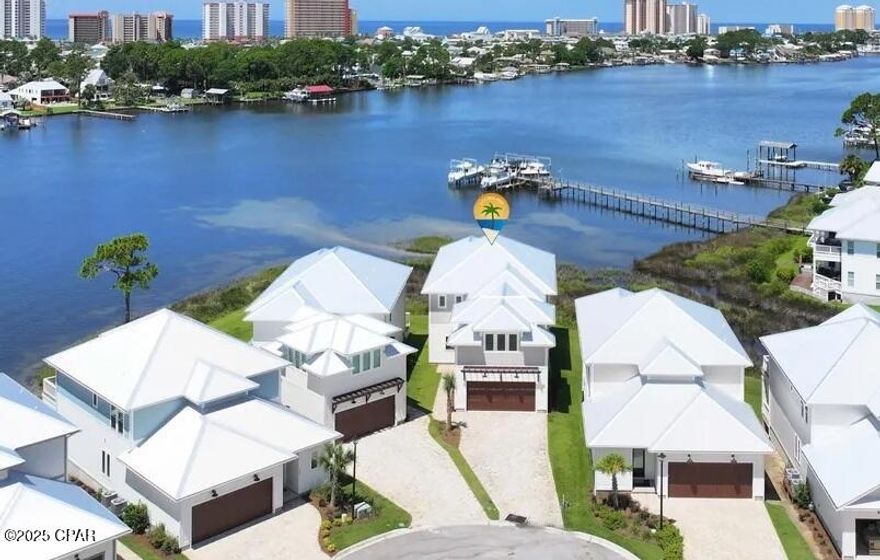 REDUCED! waterfront! HOA is 600.00 a quarter. BRAND NEW 5 Bedroom waterfront home on Grand Lagoon with assigned boat slip and gated community. This huge custom home is 3890 sq feet. Home has a downstairs master bedroom with stunning water views in 3 directions. Home is move in ready. Quartz countertops, tankless gas hot water heater, and gas stove for cooking. Hurricane windows and doors. This home has a Community pool for your enjoyment. Wonderful neighborhood and people. HOA only $600.00 a quarter, which includes landscaping. Conveniently located to popular restaurants. Hop on your boat and enjoy a day of fishing and a fun at Shell Island.