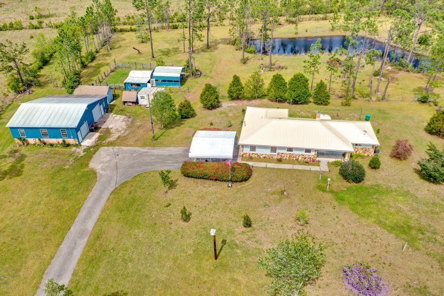 This is a multi offer situation. All offers with pof or prequal due by Friday at 2pm If you have been looking for a great home with lots of acreage for horses and multiple workshops you need to see this GREAT property. The home sits on about 8 acres and comes with an additional 1+ acre wooded lot across the street. The property has gorgeous pasture land with 2 spring fed ponds making it a GREAT spot for someone wiith horses, gardening, or fishing. The large pond is stocked with catfish. On the west side of the property there is a 36x48 Polebarn Workshop with a loft area and electricity that is perfect for anyone into wood working, mechanics, etc. There are 3 other smaller shops that could be used for storage or turned in to a hobby room/she shed. All shops are on a separate meter than the house. The property is completely fenced and cross fenced with gates and tons of beautiful trees and flowers like Knockout Roses, Confederate Jasmine, Night Blooming Jasmine, Pineapple plants, Crepe Myrtles, various Magnolia trees, Cypress Trees, Cedar Trees, Dogwood Trees, various Maple trees, Wysteria and more. The property alone will make you fall in love with the home. The metal roof was replaced in January of 2019 and there are precut, numbered hurricane boards for the windows of the home so you don't have to worry about the next hurricane. The interior of the home offers a GREAT open, split bedroom floor plan. There is a huge pantry giving you plenty or space for all your dishes, food, and overside small appliances. The living room features a wood burning stove, pine tongue and groove wainscoting, and a entertainment center made from pecky cypress. Both bedrooms are huge and offer huge walk in cedar closets. The master bedroom is plenty big enough for all your bedroom furniture as well as office furniture and has easy access to the large open back patio. The master bath has tons of cabinet space, a huge walk in shower and double vanity sinks. The A/C was replaced in November of 2019. Don't let the number of bedrooms scare you this home has tons of storage interior storage. The garage can easily be closed in to make for a 3rd bedroom and is already vented. There is so much that this great home has to offer that you really need to see it to appreciate it. Call your Realtor TODAY to see this great home.