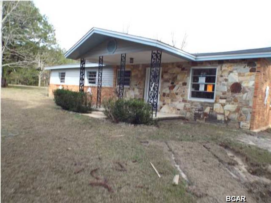 REDUCED!!! Large three bedroom two bathroom brick house with bonus room and road frontage on State Road 77 near Graceville offered as is. The property has a new roof and the inside has been white boxed. It is prepped for a new owners personal touches. All sizes approximate or taken from other sources please verify accordingly.