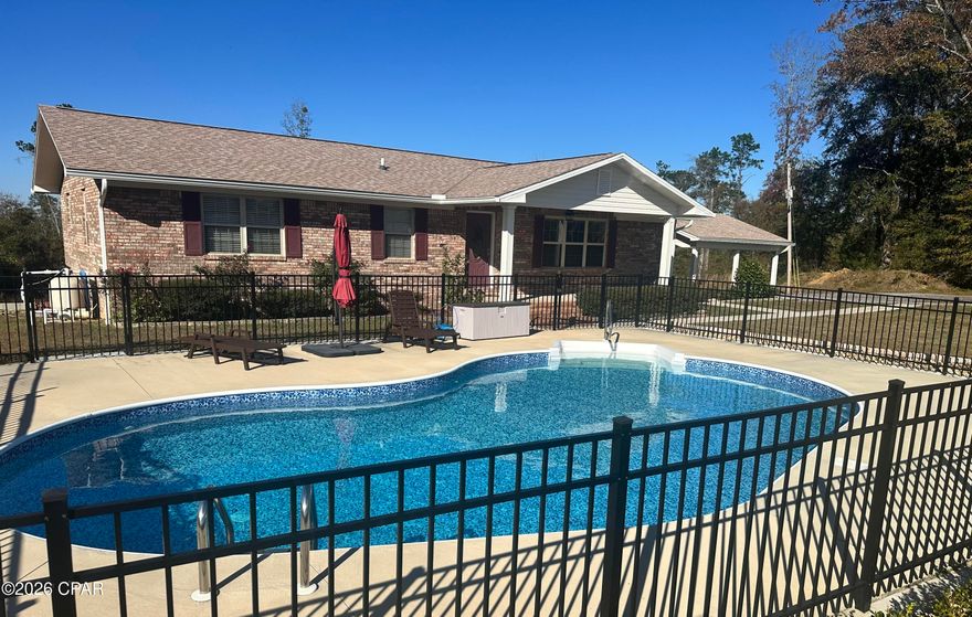 Tucked away at the end of a dead-end street, this fully remodeled 3 bed / 2 bath brick home gives you that perfect mix of privacy and convenience--right between Grand Ridge and Sneads schools.

Outside, you've got everything you need:

• Saltwater pool (fully fenced)
• 2-car carport
• 24x48 pole barn
• Storage shed with roll-up door

Inside is just as strong. Open floor plan, oversized bedrooms, and two large bathrooms. The master bath is a standout with a clean, walk-in shower that feels like it should be in a much higher price point.

Kitchen's dialed in with solid wood cabinets and stainless appliances.

And then the bonus most people don't expect--

A fully heated and cooled basement with two separate areas. Access from inside, plus two exterior entrances. Perfect for a game room, gym, extra living space... whatever you want.

Out back, you've got a double deck setup with a swing and built-in seating--made for winding down after a long day.

Bottom line... remodeled, functional, and in a location that checks all the boxes.

If you've been waiting on something like this, don't wait too long.

Let's go take a look.