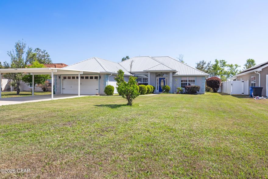Beautiful, well-maintained 3BR/2BA home with no HOA, situated on a spacious .27-acre lot and offering 1,799 sq ft of living space. Built in 2005, this home features a long list of upgrades and thoughtful touches throughout, including a 2019 hurricane-rated 26-gauge metal roof, 5'' thick concrete driveway with extended parking (poured in 2020), a hurricane rated insulated carport (2020) and 12' x 12' hurricane-rated storage building with concrete floor.
Inside, you'll find solid wood cabinetry, granite countertops, and stainless-steel appliances (stove 2024, microwave 2021, dishwasher 2020), along with 19'' porcelain tile throughout the main living areas and bamboo flooring in the bedrooms. The spacious main suite offers dual vanities, his-and-her walk-in closets, a floor-to-ceiling tiled shower with dual wall-mounted heads and ceiling-mounted rainfall fixture, plus a separate jetted tub. Additional highlights include a large laundry room with a flex space that could be utilized as an office nook or additional storage, ceiling fans throughout, custom blinds, LED lighting, and an energy-efficient Carrier HVAC system. Exterior features include a screened-in tiled back porch, covered grill area, storage building, hurricane shutters, irrigation system with well pump, and security motion lights for driveway and backyard.  This home is conveniently located with easy access to Tyndall Air Force Base, Naval Support Activity Panama City, shopping, dining, public boat ramp, and the Gulf Coast beaches. All measurements are approximate; buyer to verify if important.

Additional Notes:  
1. The roof is 26-gauge steel (25% thicker than standard residential 29-gauge steel).  Sherwin Williams finishes with high Solar Reflective Index (SRI) value, resulting in cooler attic temperatures versus other types of roofs, thus energy savings summer electricity bill.
2. New exterior Sherwin-Williams Premier Loxon XP paint (2025)
3. Radiant barrier insulation and foam insulation in the south and west facing walls.
4. Quiet belt-driven garage door opener with premium nylon rollers
5. Backyard features mature trees/bushes, arbor with grape vines, and a blueberry plant. Backyard access via easement behind home. Fenced on two sides from adjoining neighbors' fences.  Trees/bushes and shed provide privacy at back of property, but if desired can easily be enclosed. 
6. Termite bond