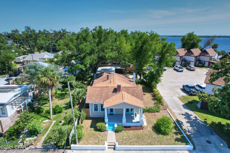 Just REDUCED $25,000...now is your time to own a Cove Home walking distance to Harrison Ave (shops, live music, restaurants) and the water. Picture your BOAT in your own driveway (storage savings) and the PUBLIC BOAT RAMP and the endless BEACH SUNSETS are just a few steps away.  Do you feel stress melting away?  This is a rare opportunity to own a classic Floridian 4 bedroom/2 bath home in the desirable Cove area of Panama City. The charm starts at the  large front porch and carries throughout. 3 original fireplaces, hardwood floors, updated kitchen and master bathroom, square footage does not include the entire back end of this home which has a  separate entrance and is currently being used as an art studio/workshop. Just imagine sitting on the front covered porch having your morning coffee or just grab a book and sit in the porch swing and unwind after a long day at work. This "Home Sweet Home" has a driveway that could easily accommodate a boat and trailer or up to 6 cars. If measurements and sq ft are important to buyer please verify. Square footage does not include office/workshop space off entire backend of this home. *Seller would consider selling furnished minus a few personal items they would remove. *If important to buyer please verify all measurements.