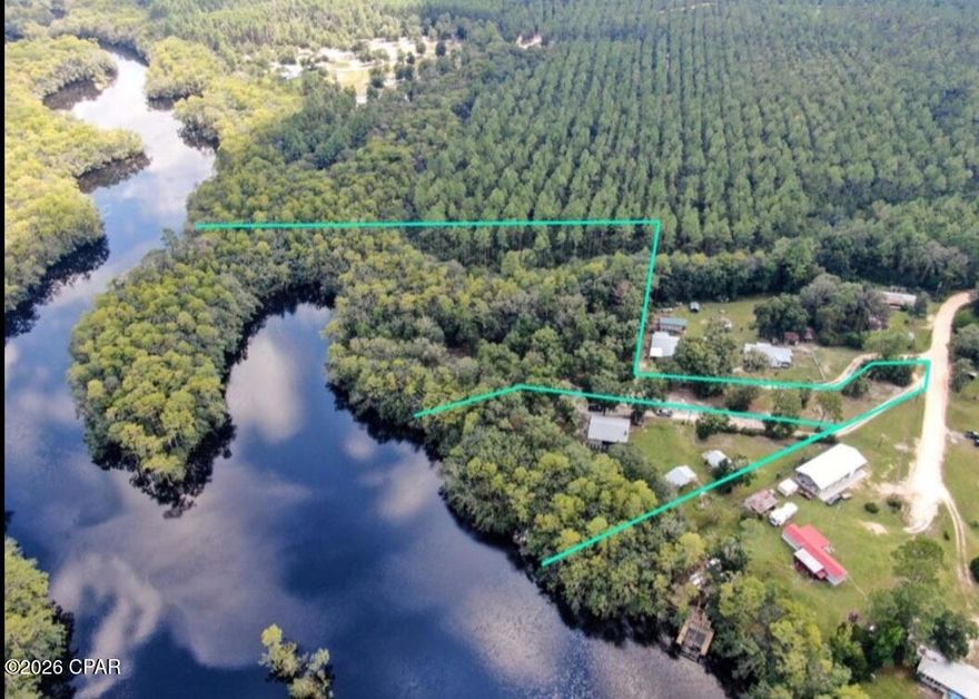 Rare East River waterfront retreat and investment opportunity offering approximately 6.76 total acres across two parcels, with deepwater access, two concrete boat launches, and a dock creating an ideal setup for boating, fishing, and waterfront living. Surrounded by the natural beauty of Pine Log Forest, this property delivers privacy, river access, outdoor recreation, and multiple income or expansion possibilities.

The primary parcel includes approximately 1.19 acres with 294 feet of East River frontage. The main residence is elevated on pilings and features 3 bedrooms, 2 bathrooms, approximately 1,040 square feet, a 1-car garage, and a 30' x 8' porch overlooking the East River and wooded surroundings. The home has been updated with luxury vinyl plank flooring, modern lighting, stainless steel appliances, kitchen and bathroom improvements, an open living and dining layout, and a fireplace. The lower level of the primary residence is partially finished and offers approximately 1,280 square feet with concrete flooring, exterior walls, plumbing, electrical, and storm windows and doors in progress, creating potential for additional living space or duplex-style use.

A separate renovated 1 bedroom, 1 bathroom guest cottage offers flexibility for guests, rental income, or multi-generational living. There is also a 16' x 14' backyard shed that may offer additional storage or future use potential.

The adjacent 5.57 acre parcel includes approximately 1,605 feet of river frontage and features a concrete deepwater cove boat launch. The parcel has been partially cleared with driveway access, and power, septic, and artesian well water are reported to be available on site. This additional acreage creates a strong opportunity for a private retreat, rental compound, tiny home concept, or build-to-suit vision, subject to zoning, permitting, and buyer verification.

The property also includes two concrete pad boat launches, a riverside dock landing area, and pier walkway access for convenient access to the river. The East River connects toward the Choctawhatchee River, Choctawhatchee Bay, and the Gulf.

Reported improvements include a 2019 architectural roof, 2020 HVAC system, 2020 50-gallon water heater, 2019 storm windows and sliding glass doors, 2022 septic leach field upgrade, 2020 LVP flooring, kitchen and bathroom updates, stainless steel appliances, and modern lighting. The detached guest cottage was built in 2011, and the backyard shed was built in 2012.

Conveniently located approximately 21 miles from the Gulf and approximately 15 miles from Northwest Florida Beaches International Airport. Seller financing may be available to qualified investment buyers.