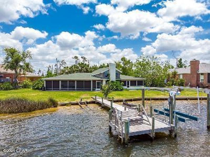 DEEP WATERFRONT that will take you anywhere in the world.  This beautiful home is a boater's dream.  There is a very small percentage of homes that you can purchase on deep water that will take you straight to the Gulf Of Mexico and this is one of them at a price you can afford.  The boat dock has a 6,000 lb wireless remote lift, fish cleaning station and a jet ski crank.  The home has many wonderful features like rear facing sunset views, lots of natural light, open floor plan, 2 screened-in patios facing the water, tile throughout, 15' ceiling, 19' granite bar in kitchen perfect for entertaining, 9' built-in server, beautiful plantation shutters throughout, 2 new a/c units, 2 new water heaters, new roof, $10k water drainage system w/ sump pump and a $2k Culligan Water Filtration system. All the rear facing rooms including the master bedroom and additional bedroom have exterior access into one of the two screened-in patios.  The open kitchen and dining is perfect for entertaining friends and guests.  You will truly be impressed by this stunning Callaway Bayou home.