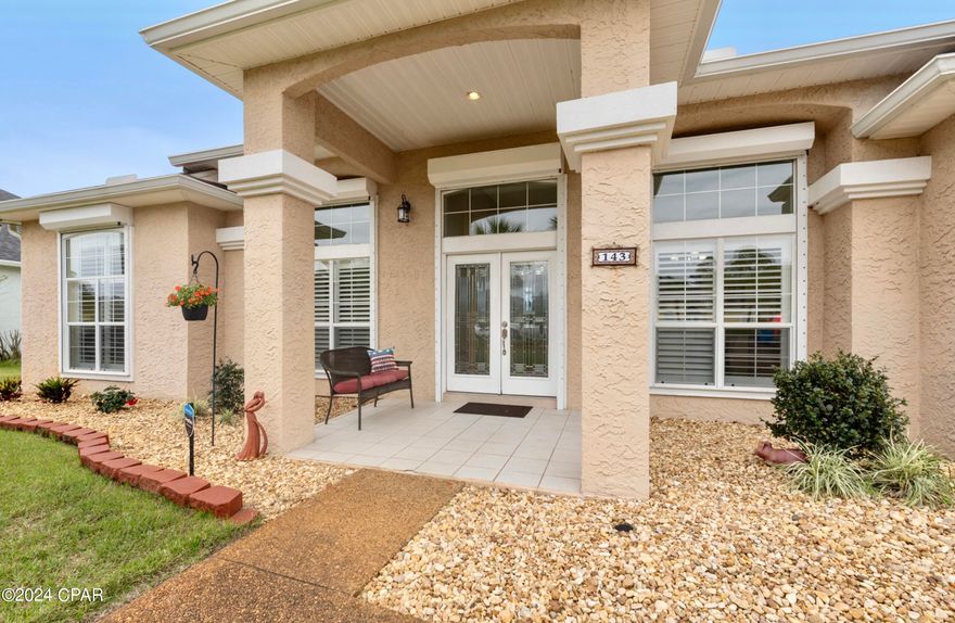 FOUR bedroom, three bath, SINGLE story home in THE GLADES! This BEAUTIFUL home, the Panama City Beach general location, AND the ESTABLISHED COMMUNITY are ALL second to none. Already LOCATED south of Hwy 98, the location will offer EVEN MORE VALUE when the six-lane project is complete. The LEAST EXPENSIVE ''CUSTOM BUILT HOME'' in the community, this home is a model for SPACE that offers both comfort AND practicality. The EXCELLENT CURB APPEAL begins with the large and neatly-landscaped front yard. The centerpiece of the covered front porch is a pair of fabulous FULL GLASS DOORS showcasing modern leaded cut glass. The light-filled foyer leads to both a front bonus space suitable as an office or a formal living room AND a bright formal dining room. The FOUR BEDROOM and three FULL bathroom home is configured in a SPLIT PLAN that offers privacy for both the MASTER SUITE and other family and guests. Bedrooms and bathrooms center around a generous FAMILY ROOM with pretty stone wood-burning FIREPLACE and a well-equipped kitchen with newer 2022 cabinets, appliances, QUARTZ countertops, touchless FAUCET, and the prettiest backsplash. The kitchen also includes pantries, a breakfast bar, and is adjacent to a BREAKFAST NOOK serving up a water view. The newer Samsung washer/dryer are INCLUDED. Overlooking the fenced back yard is a glassed in SUNROOM (an ADDITIONAL nearly 200 square feet) that will serve well as an exercise space, a reader's nook, or an artist's or gardener's palette and has direct access from the family room, master bedroom, and a GUEST SUITE.  Interiors include a beautiful combination of newer HARDWOOD and PORCELAIN TILE FLOORING as well as PLANTATION SHUTTERS throughout. CEILINGS are TEN feet...and higher. The electrical panel and WATER HEATER are 2024 new. The SEASON is HERE...on the exterior, windows and FRONT DOOR are equipped with STORM SHUTTERS, noted on a photo. The GARAGE DOOR is also RE-ENFORCED; the pebbled DRIVEWAY exceptionally LARGE! LOW MAINTENANCE soffits are vinyl AND there is a leaf filter on the gutters. The ROOF was replaced in 2020, and your MAILBOX is located right at the end of your own large driveway! The LOW HOA FEE includes TRASH SERVICE.  The garage floor was just resurfaced with EPOXY and looks great! This home has a general IDEAL LOCATION that puts you within minutes of what BOTH sides of the Hathaway Bridge offer...shopping, dining, entertainment, educational opportunities including a Florida State University branch, and the SUGAR SHORE of renowned BEACHES. Look for a MAJOR EXPANSION to PIER PARK CITY CENTER to the west! You won't even have to leave this beautiful community to enjoy LIVE ENTERTAINMENT, WINE TASTING, and the GIFT SHOP at DUPLIN WINERY! As stated...SECOND to NONE!