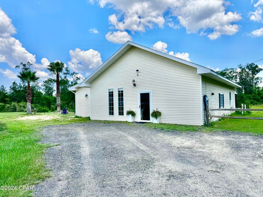 PRICE TO SELL FAST!  Welcome to the country! This charming property boasts a tranquil setting on 1.69 acres of land, perfect for those seeking a peaceful retreat from the hustle and bustle of city life. The 2 bedroom, 2 bathroom home offers a spacious 1619 square feet of living space, with a master bedroom featuring a cozy fireplace to snuggle up by on chilly evenings. The screened-in back porch is the perfect spot to relax and take in the serene surroundings, while the wet bar adds a touch of sophistication for entertaining. With only a 55-minute drive to some of the world's most beautiful beaches, this property offers the best of both worlds: country living and easy access to coastal fun. Also has enough sq ft to add a 3rd bedroom.