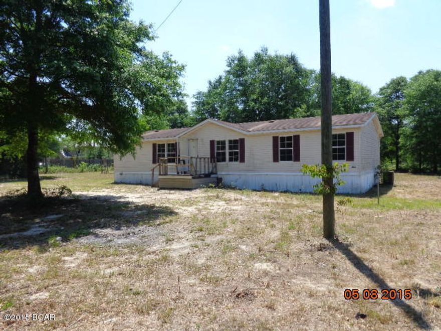FORECLOSED DOUBLEWIDE MOBILE HOME ON 6+ ACRES 1/4 MILE FROM PAVED ROAD. PART OF LAND IS CLEARED. THERE IS A METAL 2 CAR CARPORT OUT BACK OF THE HOME. Info FROM PROPERTY APPR. WEBSITE, PLEASE VERIFY IF IMPORTANT. HOME NEEDS SOME WORK.--BRING  ALL  OFFERS.  --CALL FOR YOUR APPT. TODAY
