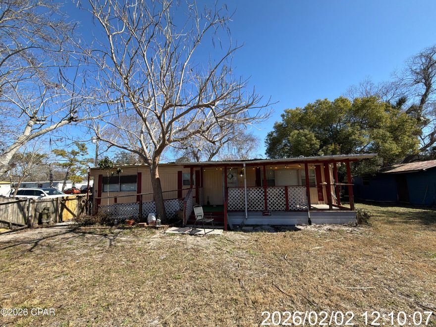 Nice lot with usable home and storage building. The lot is fenced the home features both front and back covered porches. Located just a golf cart ridge away from the prime sandy white beaches.
