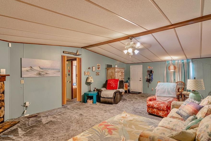 This cozy 3 bedroom 2 bath home is located on a corner lot in the west end of PCB. The desirable Laguna Beach area is conveniently located next to popular dining, shopping, Pier Park and scenic 30-A.. Approximately 1,700 ft to the sugar white sands. With over 1600sf, a spacious split floor plan and a large family area, this home creates the perfect setting for family gatherings. The home features vaulted ceilings and a wood burning fireplace in the living room. Other highlights include a storage shed in the fenced in backyard, metal roof and a large porch. The open eat-in kitchen includes updated appliances, backsplash and plenty of counter space to prep your favorite meals. Master bath has updated vanity and sink. Jump on your golf cart for a short ride to the beach and enjoy breathtaking sunsets.This is a must see, call to schedule a showing today.