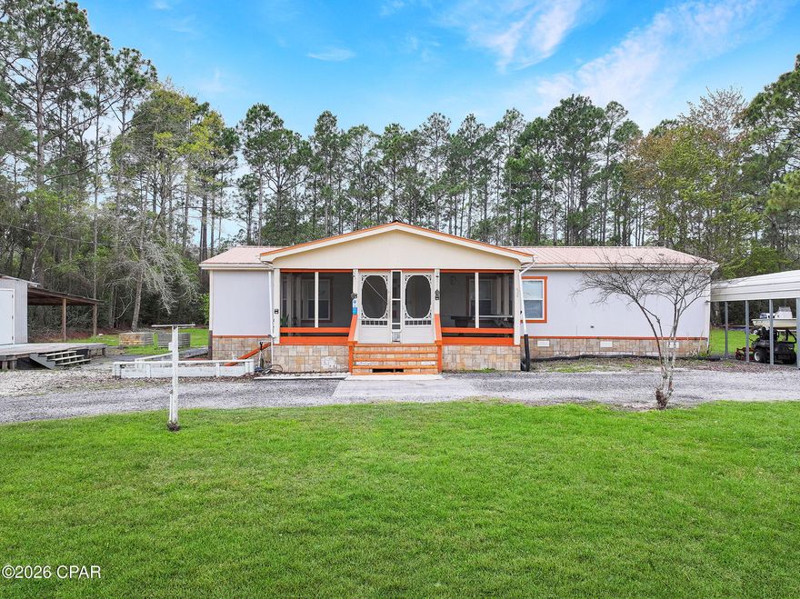 Enjoy the freedom of country living on this 1-acre property with no restrictions, located just minutes from Apalachicola River boat ramp and easy bay/gulf access. This 3-bedroom, 2-bath mobile home has been nicely renovated and well cared for, waiting for you to add your touch. Relax on the screened-in front porch, perfect for enjoying the outdoors year-round. The property offers plenty of space for all your toys with room for boats, RVs, and additional parking. A standout feature is the charming she-shed complete with electricity, water, and air conditioning, ideal for a hobby space, workshop, or private retreat. You'll also find multiple storage buildings providing ample room for tools, equipment, and outdoor gear. And covered parking for your boat. Room for gardening and livestock, including an orange tree, gravevine and chicken coops. Located just minutes from charming downtown Apalachicola shopping, dining, parks and marina. With space, flexibility, and convenient access to the water and hot spots like St. George Island, this property is perfect for those looking to enjoy coastal living with room to spread out. 3D tour available