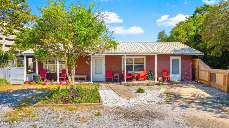 Priced to sell and embodying the essence of Old Florida charm, 610 West Caladium Circle in Open Sands, Panama City Beach, is a rare gem awaiting its new owner. This heritage Florida cottage boasts 1584 heated/cooled square feet and is nestled on a spacious, pie-shaped lot adorned with majestic heritage trees and planters, offering a serene and picturesque setting. Situated just steps from Front Beach Road and less than 1,100 feet from the Gulf of Mexico, residents can relish in the tranquil sound of waves crashing on quiet nights, all without the need for flood insurance thanks to its Flood Zone 'X' designation.

The home welcomes you with a quaint double driveway leading to an inviting open porch, perfect for enjoying sunny days and evenings in rocking chairs. Inside, the open and airy layout presents three bedrooms and 1 bathroom, with the potential for expansion in the enclosed garage, ripe for conversion into separate living space. The living room flows seamlessly into a beautifully appointed kitchen boasting ample storage cabinets. The master bedroom offers direct access to the back patio and backyard, while two private bedrooms cater to guests, one of which can be easily transformed into an office or entertainment room. Revel in the quiet, Old Florida feel of the neighborhood, where friendly neighbors and the absence of an HOA enhance the appeal of this truly unique property. Discover why homes like this are so highly coveted and schedule a showing today and make this legacy Old Florida home your own, whether as a primary residence or a cherished second home (note: no short-term rentals allowed at this address).