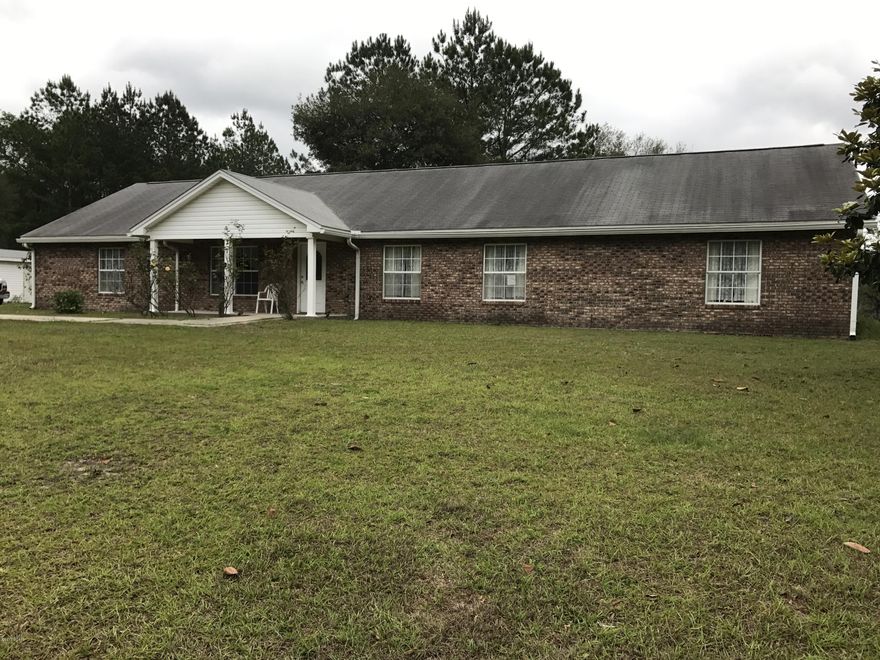 Beautiful 35 acres with grape vines and fruit trees! Lovely all brick home with a view of the largest of 3 ponds on the property.There is a large pole barn with a storage room and a pump house/utility room. The house boasts a stone fireplace in the family room and a Florida room with large windows that can be closed. There is a self charging propane generator that can run the entire house. The house is handicap accessible and one bathroom has an open shower, grab bars, and is completely handicap outfitted. The front door has a lovely leaded glass insert and the kitchen cabinets are birch. The deep well has a water conditioner and filter system. Refrigerator, freezer, washer and dryer convey. Sq ft and measurements are approximate and should be measured if important. Square footage and all measurements are approximate and should be measured if important.