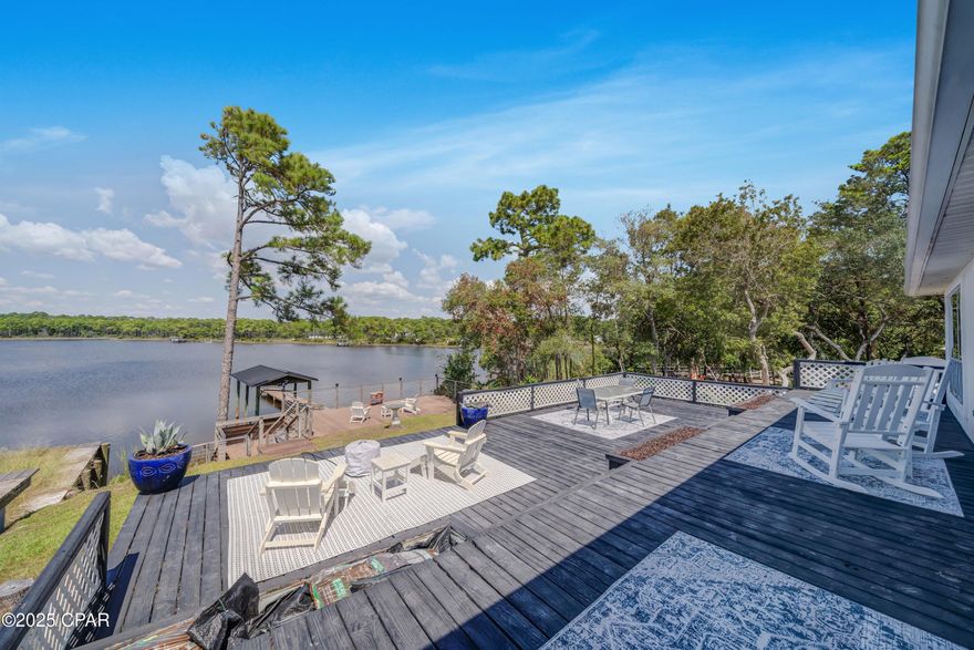 Lakefront living on Lake Powell! Bring your boat, jet skis, and paddleboards...your waterfront lifestyle awaits!  This 3 bedroom, 3 full bath home at 21926 Lakeview Drive sits directly on Lake Powell, Florida's largest coastal dune lake.  This is the perfect location on the west end, just minutes from the sugar-white beaches of Panama City Beach, Inlet Beach, and 30A.  Enjoy elevated views of the water from the living room, dining area, and master suite. Features include a metal roof, luxury vinyl plank flooring, spacious back deck,  new privacy fence, private boat dock, and a 2-car garage.  Recent updates make this home move-in ready: including freshly painted roof, custom slider that opens all the way to back deck, updated bathrooms, brand-new kitchen appliances (never even used!), and more! This rare and tranquil lakefront setting allows you to kayak or paddleboard all the way to the Gulf!  Enjoy lakefront living with no HOA, and a tucked away location that is private, yet also so close to the shopping, dining and activities of Inlet Beach, 30A and Panama City Beach.  This home is offered furnished, so move right in - perfect for full-time residence, vacation getaway, or rental investment.  Short term rental allowed!  Don't miss this opportunity to own a piece of waterfront paradise - schedule your showing today!