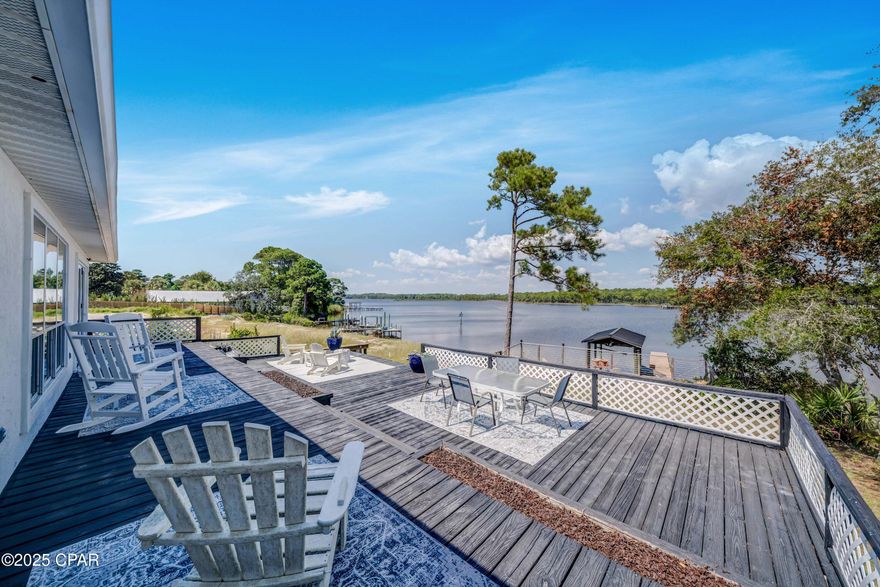Lakefront living on Lake Powell! Bring your boat, jet skis, and paddleboards...your waterfront lifestyle awaits!  This 3 bedroom, 3 full bath home at 21926 Lakeview Drive sits directly on Lake Powell, Florida's largest coastal dune lake.  This is the perfect location on the west end, just minutes from the sugar-white beaches of Panama City Beach, Inlet Beach, and 30A.  Enjoy elevated views of the water from the living room, dining area, and master suite. Features include a metal roof, luxury vinyl plank flooring, spacious back deck,  new privacy fence, private boat dock, and a 2-car garage.  Recent updates make this home move-in ready: including freshly painted roof, custom slider that opens all the way to back deck, updated bathrooms, brand-new kitchen appliances (never even used!), and more! This rare and tranquil lakefront setting allows you to kayak or paddleboard all the way to the Gulf!  Enjoy lakefront living with no HOA, and a tucked away location that is private, yet also so close to the shopping, dining and activities of Inlet Beach, 30A and Panama City Beach.  This home is offered furnished, so move right in - perfect for full-time residence, vacation getaway, or rental investment.  Short term rental allowed!  Don't miss this opportunity to own a piece of waterfront paradise - schedule your showing today!