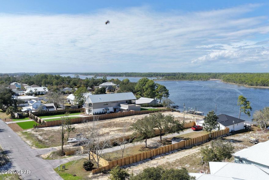 Lakefront living on Lake Powell! Bring your boat, jet skis, and paddleboards...your waterfront lifestyle awaits!  This 3 bedroom, 3 full bath home at 21926 Lakeview Drive sits directly on Lake Powell, Florida's largest coastal dune lake.  This is the perfect location on the west end, just minutes from the sugar-white beaches of Panama City Beach, Inlet Beach, and 30A.  Enjoy elevated views of the water from the living room, dining area, and master suite. Features include a metal roof, luxury vinyl plank flooring, spacious back deck,  new privacy fence, private boat dock, and a 2-car garage.  Recent updates make this home move-in ready: including freshly painted roof, custom slider that opens all the way to back deck, updated bathrooms, brand-new kitchen appliances (never even used!), and more! This rare and tranquil lakefront setting allows you to kayak or paddleboard all the way to the Gulf!  Enjoy lakefront living with no HOA, and a tucked away location that is private, yet also so close to the shopping, dining and activities of Inlet Beach, 30A and Panama City Beach.  This home is offered furnished, so move right in - perfect for full-time residence, vacation getaway, or rental investment.  Short term rental allowed!  Don't miss this opportunity to own a piece of waterfront paradise - schedule your showing today!