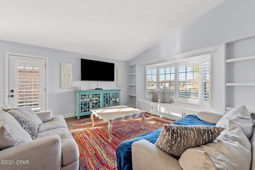OPEN HOUSE Sun 11/21 1:30-3:30!  What a steal! This home has been rebuilt from the studs in, is move in ready and could potentially be maintenance free for years!  New metal roof, new windows, spray foam insulation, new AC and ductwork, new water heater and so much more! The layout feels open and comfortable with its 2 bay windows, vaulted ceilings, skylights, and bright finishes. The owner thoughtfully renovated the home with quality in mind. A few of the upgraded features are custom plantation shutters, wood-look ceramic tile complemented by 5-inch baseboards, a whole home air purifier, oversized ceiling fans, and built-in bookshelves. The chef will appreciate the new kitchen cabinets, granite countertop, new stainless appliances, and the refrigerator (flex-fridge) is convertible into a full freezer. The master bedroom is of good size and has a patio door that opens to the peaceful back yard with no neighbors behind you. The laundry room is oversized and a great space for storage. The garage is outfitted with a 220v outlet to charge an electric car and comes with a new garage door and track and 2 ceiling fans to keep you cool while working. Landscaping includes established fruit trees, including blood orange, navel orange, Meyer lemon and blueberry, and the backyard overlooks a charming pond. Pull up your Adirondack chair and enjoy a peaceful morning by the water. Located on a cul-de-sac, you don't have to worry about through traffic and being situated in central Panama City you are only blocks from shopping and just 20 minutes to the beach. Transferrable termite bond in place. No HOA or required flood insurance! Measurements approximate, buyer to verify if important.