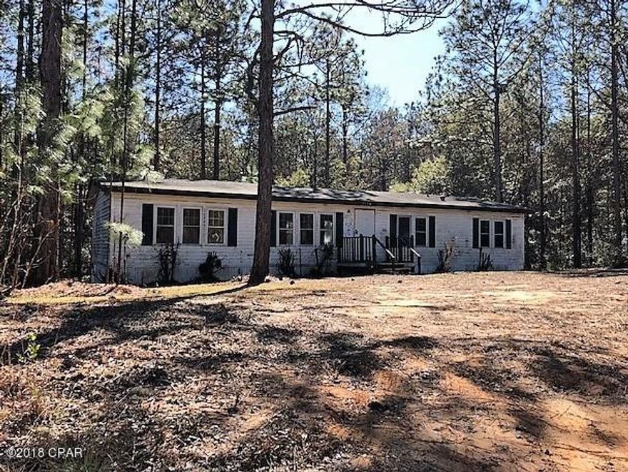 This pretty wooded 1 acre lot is in the country near an area of lakes and woods for hunting. There is a 4 bedroom 2 bath mobile home on it that you could completely renovate or remove it from the lot and place your own there or build a house. Good property with potential.