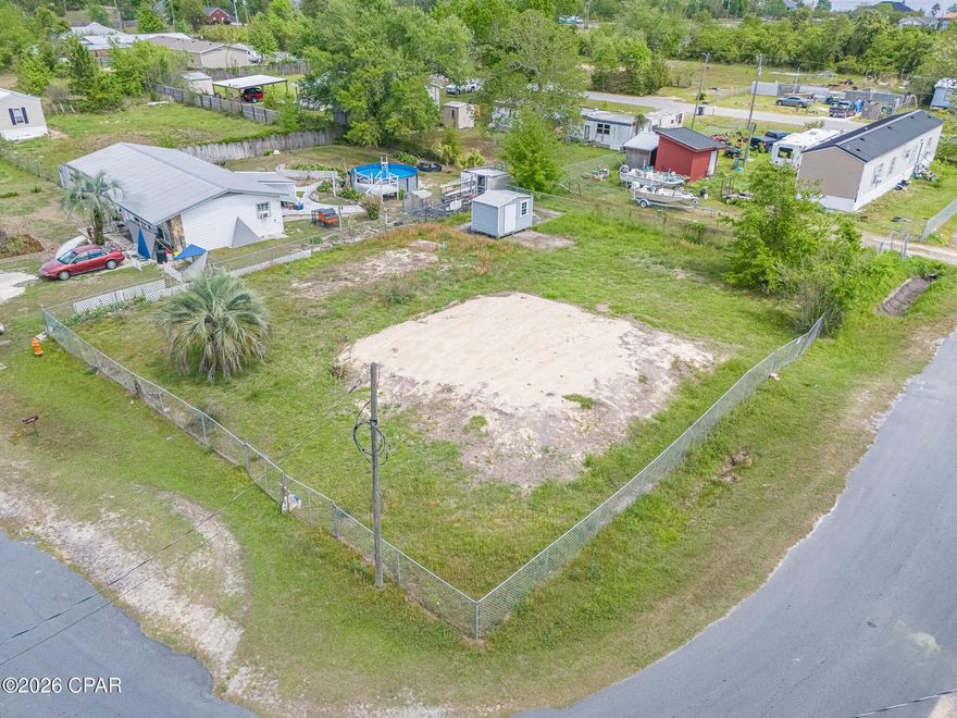 Level and nicely prepared 1/4 acre lot.  Brand new $17,000. fully permitted 1,050 gallon septic tank with drain fields that allow a home as large as 2,550 sq. ft.  Pad site prepped with enough fill dirt to not require a pump and does not have an indian temple mound appearance.  Chain link fenced with a dog run.  Concrete pad site for a shed also.