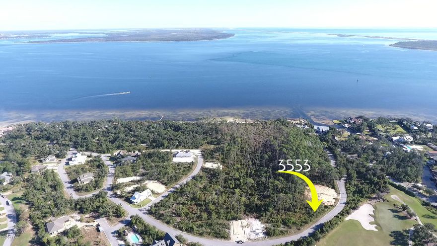Perfect location to build your dream home, this large lot is directly across from Bay Point's Nicklaus Golf Course and backs up to protected wooded areas.  Sanctuary Beach is a gated coastal community in the quiet and private end of Delwood Beach Road.  The community offers a relaxed coastal lifestyle to residents with a community pool and low HOA dues. It is located in close proximity to the golf course at Bay Point, nearby area marinas and the white sands of Panama City Beach.