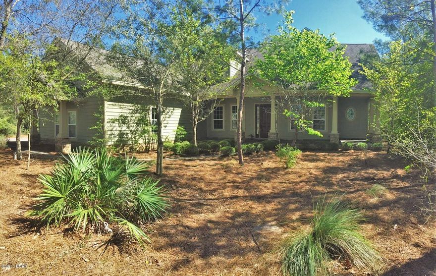 GATED COMMUNITY OF LAKE MERIAL - 5 BEDROOM CUSTOM HOME on 1/2 ACRE! The interior of this home features 5 XL bedrooms, 2 full baths, 1 half bath, over 3,000 square feet, 2 stories, an open floor plan and upgrades galore!  This was the Home Builder's Association Showcase home in 2008.  Every room has upgrades. The gourmet kitchen features custom cabinets, quartz countertops, convenient built-ins, an island with gas cooktop, upgraded fixtures with LED lighting, travertine flooring, a breakfast bar, a 14x10 breakfast area and a 4x4 pantry. The 24x17 living room has a gas fireplace with stone accents, a stylish coffered ceiling, hand scraped hardwood flooring and is open to the dining room and foyer.  The 14x12 dining area is framed with stacked stone craftsman style columns. The 17x13 master bedroom is located on the first floor and has an adjoining bath with 2 vanities, custom cabinets, a Jacuzzi tub, a separate shower with jets and 2 closets with custom built-ins. There is one more bedroom downstairs that could also serve as an office (has a walk-in closet). Upstairs features 3 bedrooms and a hall bath.  Two of the Bedrooms have a 11x5 dormer space with built-in desk.  There is storage throughout this home in addition to a HUGE attic.  Extras: Sprinkler System, Security System, Jetted Utility Sink in Laundry Room, 2 HVACS, Tankless Gas Rinnai Water Heater and Crown Molding throughout. The exterior features 748 square feet of covered porches, a large paver driveway and walkways, an oversized garage and natural landscaping. Most of the property is still wooded to give plenty of privacy. Lake Merial is a gorgeous gated community with sidewalks and stunning houses and landscaping throughout the community. This upscale community is unlike others. Call today to see for yourself. All information derived from public record and owner; buyer to verify if important. Measurements approximate.