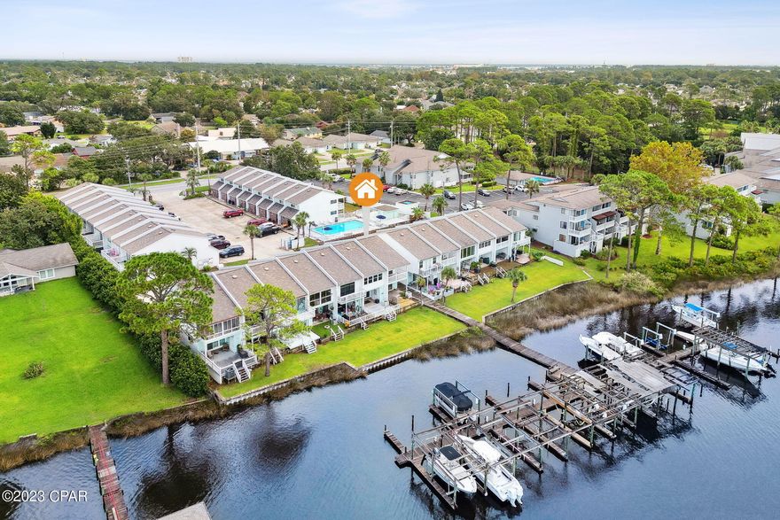Live your best life on the lagoon, with access to the Gulf of Mexico, in this two bedroom, two and a half bath Landward townhome with designated boat lift and slip.  This townhome has an ''end'' unit feel, with a breezeway between it and the neighboring townhome to the left. New LVP flooring upstairs in the two bedrooms and on the stairs. Landward community pool.
