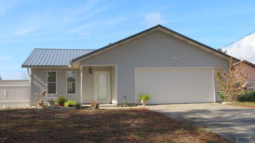 Priced to Sell! Don't miss out on this spacious 3 Br/2 bath home. Close to schools, shopping, Tyndall AFB, fishing spots and close to a public boat ramp. This home has been updated with tile flooring in the living area, bath rooms & kitchen and wood laminate  flooring in the bedrooms. The huge living room features a  vaulted ceiling and is adjoined by a  formal dining room. All appliances in the  spacious eat-in-kitchen are included. The heating/cooling system was replaced in 2011 & the garage door is only a few years old.  A new metal roof was installed in 2016. The exterior is low maintenance vinyl siding and never needs painting. 2 car garage w/auto opener. Privacy fenced  backyard, and a  small patio area is accessible from the living room. Seller will provide a One Year Home Warranty!