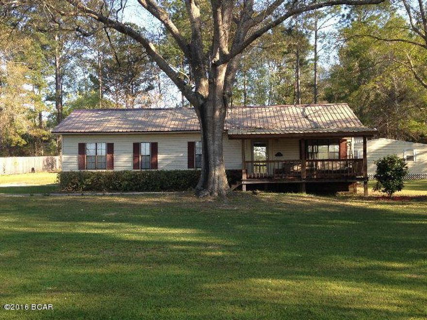 This cozy 3 bedroom 2 bath home located just outside the city limits has new metal roof, large front porch, attached carport, fireplace, master bed/bath with walk-in closet, eat-in kitchen and much more. Outside you will find large backyard with privacy fencing, two outdoor sheds and an enclosed 24x36 workshop that is insulated, wired and has large roll-up door. Property is located within walking distance of schools and minutes from hospital, stores and restaurants.