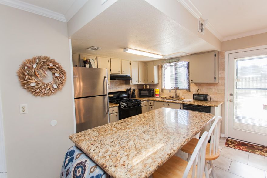 Come see this beautifully remodeled townhome in the highly sought after Gulf Highlands. You will love everything about this home, from the amazing kitchen with granite counter tops, stainless steel appliances, tiled backsplash, gorgeous flooring throughout, beautiful bathrooms and more!  Don't miss out on seeing this condo before it's gone!