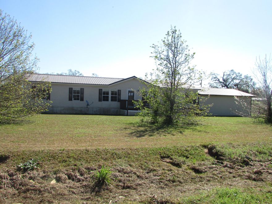 Large DWMH Located in Marianna will NOT LAST LONG!! 4 Bedroom 2 Baths with 1716 sq. feet, Sitting on 1.50 acres!! Large Family room with fireplace and French sliding doors leading to the back covered porch. Split Bedroom plan with laminate wood floors thru-out home except for bedrooms. Attached 24x26 carport. Call us today for your personal showing before this home is SOLD!!