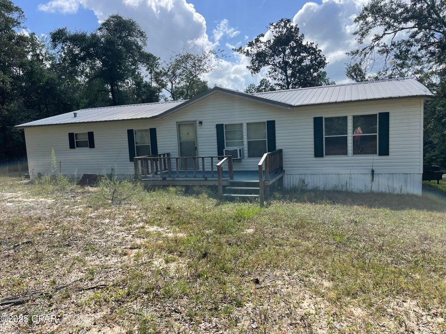 New central air/heat just installed with a 10-year warranty!  MOTIVATED seller!  This 1800 sq. ft., 3 bedroom 2 bath, mobile home sits on 1.4 acre in a quiet cul-de-sac in Compass Lake in the Hills.  This home has an open concept, a cozy family room with a wood burning fireplace, and a kitchen that has newer stainless steel appliances with a large pantry.  This property includes 2 outdoor newer buildings.  One is 10'x16' with electric and a roll-up door.  The other is 8'x10' and looks to be wired for electric.  Home is centrally located with less than an hour to Panama City.