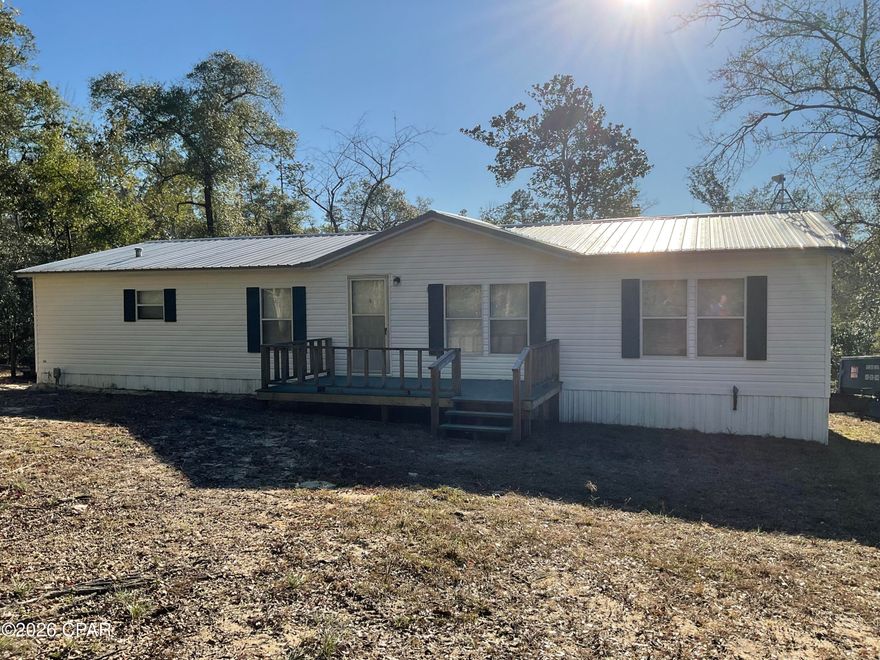 New central air/heat just installed with a 10-year warranty!  MOTIVATED seller!  This 1800 sq. ft., 3 bedroom 2 bath, mobile home sits on 1.4 acre in a quiet cul-de-sac in Compass Lake in the Hills.  This home has an open concept, a cozy family room with a wood burning fireplace, and a kitchen that has newer stainless steel appliances with a large pantry.  This property includes 2 outdoor newer buildings.  One is 10'x16' with electric and a roll-up door.  The other is 8'x10' and looks to be wired for electric.  Home is centrally located with less than an hour to Panama City.