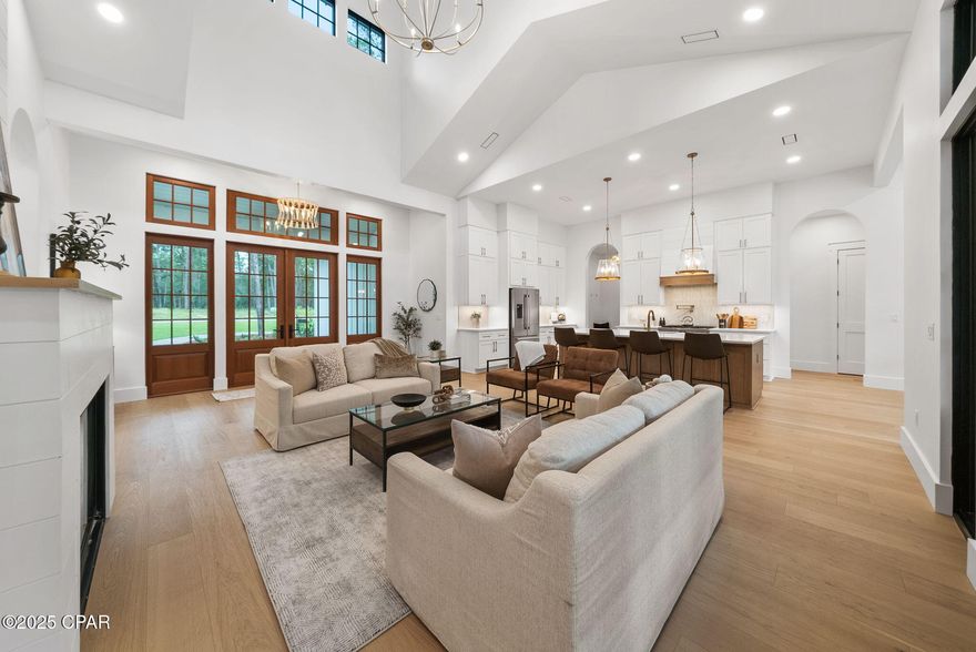 This stunning NEW CONSTRUCTION, single level home in Wild Heron is where modern craftsman design meets resort-style living. Welcome to a home where timeless design and modern luxury meet coastal serenity—just minutes from 30A and nestled within the gates of Wild Heron, one of Panama City Beach's most desired, fast growing communities on the shores of Lake Powell.

Thoughtfully designed and construction just completed, this highly desirable, single-level masterpiece spans 3,300 square feet under roof and offers 2,401 square feet of interior living and over situated on a generous .37-acre homesite that backs up to conservation area offering both privacy and peaceful views.

From the moment you step through the 8' solid Mahogany French doors, you're greeted by a sense of understated luxury. As you enter, you're greeted by a showstopping 24' cathedral vaulted ceiling in the living room, 12' ceilings flowing throughout, and an open concept anchored by a natural gas fireplace. Arched doorways add architectural charm and warmth, while modern, black Andersen windows and French doors to the patio flood the space with natural light. Step outside the living area to your private oasis where you'll find your own private, saltwater pool surrounded by a pavered deck, lush landscaping, and a vaulted, covered back porch plumbed for an outdoor kitchen. 

The open-concept layout is both inviting and functional, perfect for effortless entertaining and everyday living. Enjoy white oak flooring throughout, along with a curated palette of classic tile selections in the bathrooms, mudroom, and a standout black-and-white checkered tile mud room and butlers pantry. 

The kitchen is timeless and classic featuring white shaker custom cabinetry on the perimeter with a warm white oak wood island, Quartz countertops, and a full suite of Bosch appliances, seamlessly blending style and utility. A spacious butler's pantry off the mudroom and kitchen adds even more prep space with built-in shelving, generous counters, and a beverage fridge.

The primary suite is a true retreat with stunning conservation area views, shiplap clad vaulted ceilings, a spa-like primary bath with a soaking tub, zero-entry tiled shower, and a custom walk-in closet with double vanities paired with modern tile selections. With four bedrooms and three baths, this home offers a split floor plan that prioritizes privacy and comfort. All bedrooms offer walk-in closets, three bedrooms of the four bedrooms feature vaulted ceilings and a generous size Jack n' Jill bath with separate vanity areas allow for the best use of the third bathroom. 

The 2-car garage offers tall ceilings for expanded storage and an EV-car charger for convenience of those with electric vehicles or golf carts. Crafted with enduring materials—brick and Hardie siding, this home captures the charm of classic craftsman style with the function and efficiency of modern construction with a coastal elegant twist. 

Spanning 734 pristine acres along the shores of Lake Powell, Florida's largest coastal dune lake, this extraordinary community invites residents to slow down, breathe deeply, and savor the beauty that surrounds them. Morning strolls along miles of tree-lined walking trails, afternoons spent lounging at the resort-style lakefront pool, and evenings by the boathouse pavilion watching the sun set over the water, this is the rhythm of life here. With access to a community dock, fitness center, playground, and the opportunity to lease private boat slips with power lifts, Wild Heron was built for those who crave both adventure and serenity.

For those seeking the ultimate in exclusivity, Watersound Club membership elevates the experience with multiple private Club opportunities. In Wild Heron, enjoy the challenge of Shark's Tooth Golf Club, a Greg Norman-designed 18-hole masterpiece as a Private Club Member.