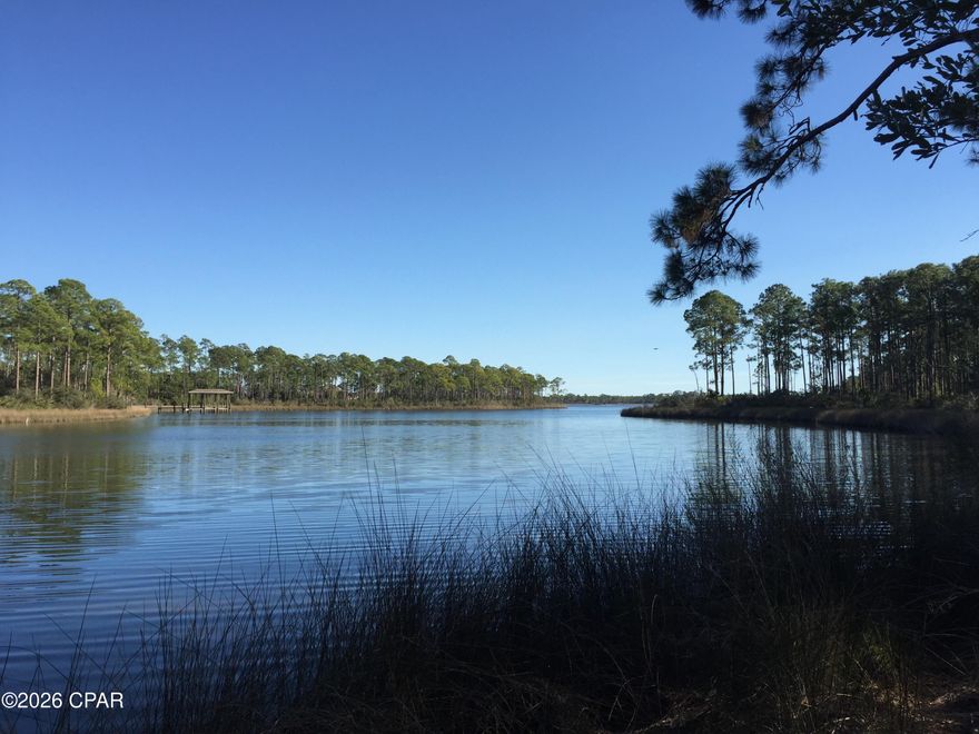 Remarkable waterfront lot in the gated neighborhood of Laird Point. Laird Point is a quiet gated coastal community set on a peninsula with breathtaking views of East Bay, which leads to the Gulf of Mexico. This lot has 161' of deep water frontage: minimal wire grass and one of the few deeded dockable lots. This property has a 1600sf transferable dock permit that has HOA approval. Lot 39 is a prized location for a resident wanting an Eastern-facing water view. Geotechnical Report describing foundation options available upon request. Close to the social attractions of nearby Panama City and Tyndall Air Force Base. New homes are being built in the neighborhood now.